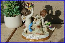 Antique capodimonte marked porcelain Putti angel grapes parrot bird statue group