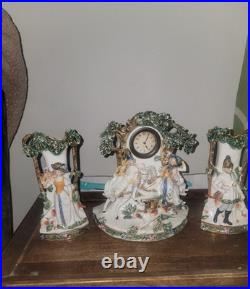 Three piece Antique Porcelain Clock Germany made. Man and woman horse, dog bird