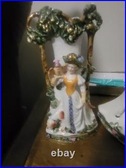 Three piece Antique Porcelain Clock Germany made. Man and woman horse, dog bird