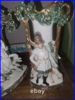 Three piece Antique Porcelain Clock Germany made. Man and woman horse, dog bird